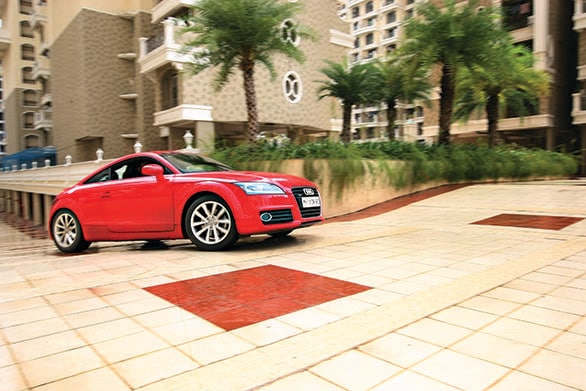 What is it The Audi TT is a compact sports car and one of the most affordable coupes available today. The four cylinder 2.0 litre engine may seem underpowered on paper but actually packs a V6 like punch. The car boasts four seats despite a low ride height and roofline.