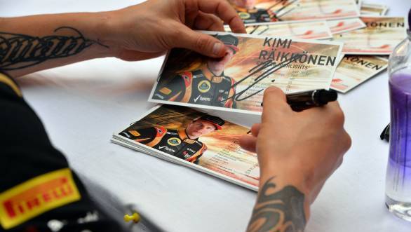 Kimi Raikkonen (FIN) Lotus F1 at the autograph session. 