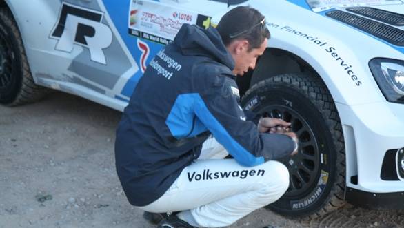 Ingrassia does some quick checks on the car before it heads off once again