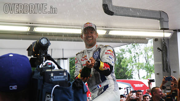 Seb Ogier sprays some champagne right on Team OD's camera after coming into the service park at Rally Poland 
