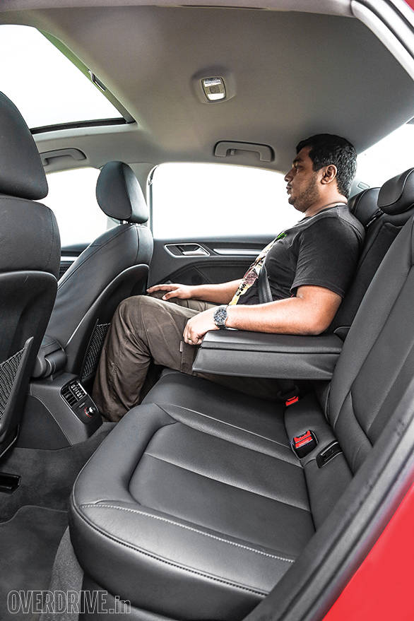 While knee and leg room are adequate, Alan's head touches the roof in the rear seat
