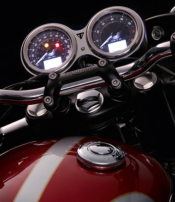 New twin-pod meters nearly hide the most convenient of upgrades on the 2015 Triumph Bonneville range - the ignition key slot is where it always should have been now. The left pod looks busy but has kmph and mph speedo, warning lights including traction control. Right meter is a tachometre. Twin LCD panels bring a range of digital information including gear position and traction control mode (rain or road on the T120). The 2016 Triumph Thruxton shares the meters but the styling is slightly different