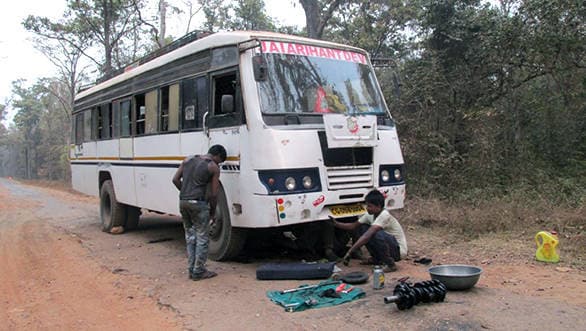 Engine being rebuilt on the road. Can only happen in India