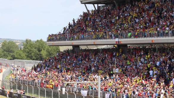 Fans in the main grandstands move to the side that gives them the best view of the Yamaha garage!