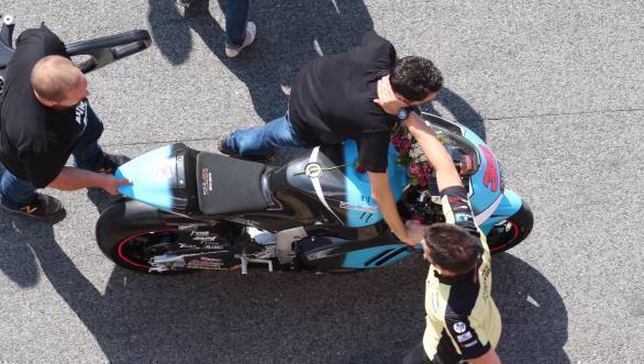 Mechanics wheel Luis Salom's motorcycle back into the garage after the MotoGP paddock bid the fallen rider a tearful goodbye