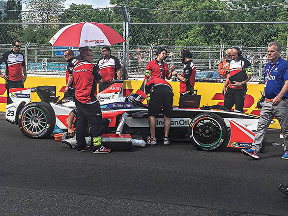 On the grid before the race, the Mahindra crew makes sure everything is ready for Heidfeld