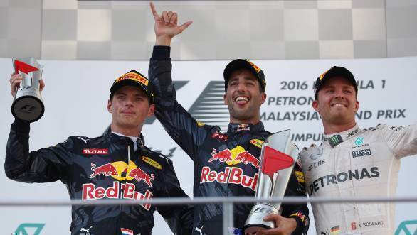 Daniel Ricciardo stands on the podium after winning the 2016 Malaysian GP, flanked by Red Bull Racing team-mate Max Verstappen and Mercedes driver Nico Rosberg 