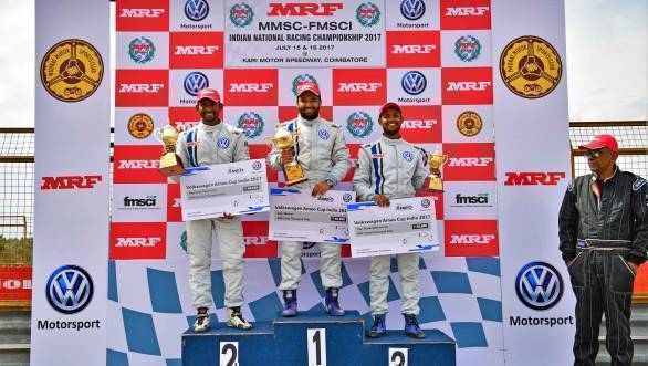 Karminder Singh in first place, flanked by second-placed Sandeep Kumar and third-placed Aditya Pawar on the podium for Race 1 of the Ameo Cup.
